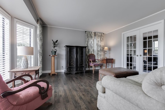 living room with dark hardwood / wood-style flooring, crown molding, and french doors