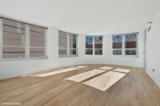 unfurnished room featuring light hardwood / wood-style flooring