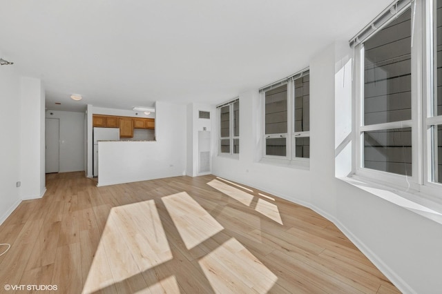 unfurnished living room with light hardwood / wood-style flooring