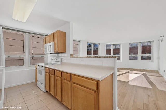 kitchen with tasteful backsplash and white appliances