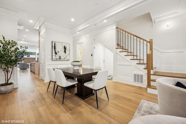 dining room featuring light hardwood / wood-style floors and ornamental molding