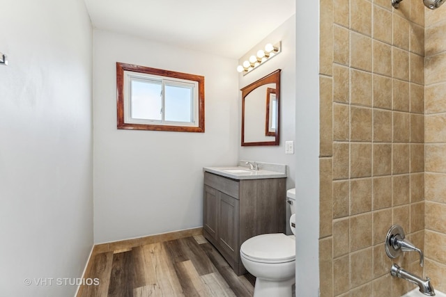 bathroom featuring vanity, wood-type flooring, and toilet