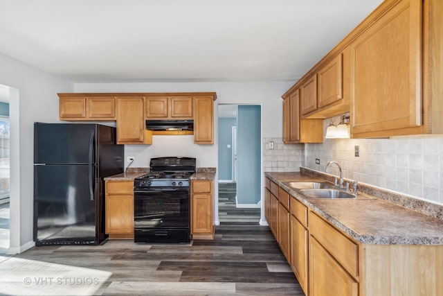 kitchen featuring black appliances, backsplash, dark hardwood / wood-style flooring, and sink