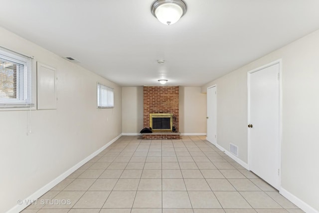 unfurnished living room with light tile patterned floors and a fireplace