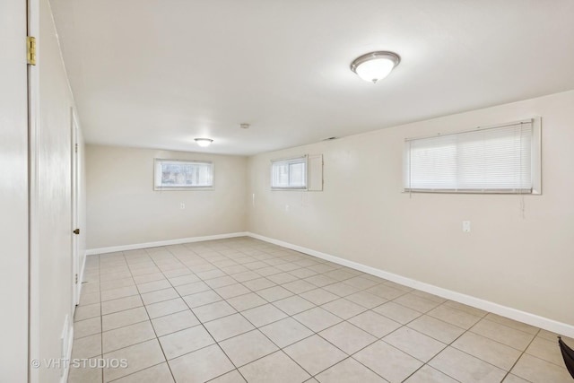 basement with a wealth of natural light and light tile patterned floors