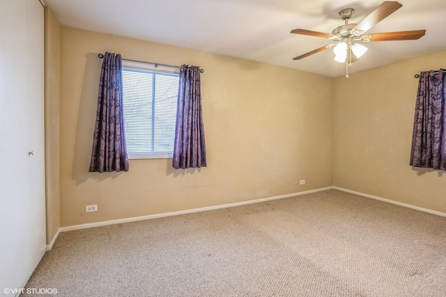 carpeted empty room featuring ceiling fan