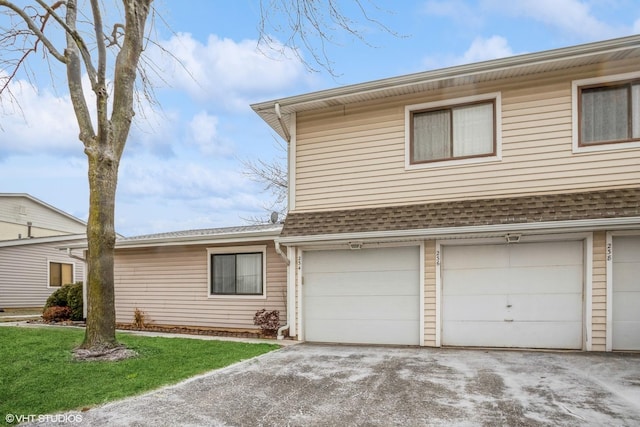 front of property featuring a front yard and a garage