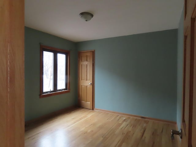 unfurnished room with light hardwood / wood-style floors