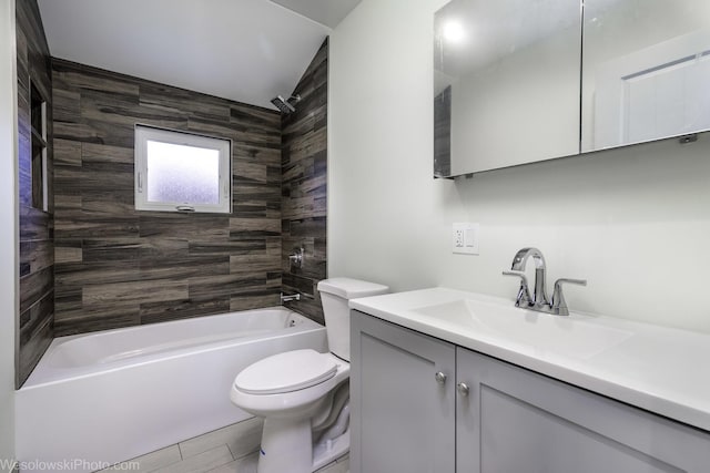 full bathroom with toilet, tiled shower / bath, and vanity