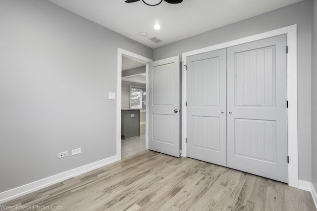 unfurnished bedroom with light hardwood / wood-style floors and a closet