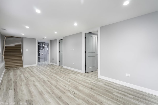 basement with light hardwood / wood-style flooring