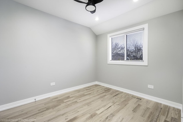 unfurnished room featuring ceiling fan, lofted ceiling, and light hardwood / wood-style floors