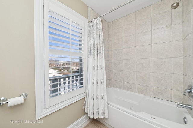 bathroom with shower / bath combination with curtain