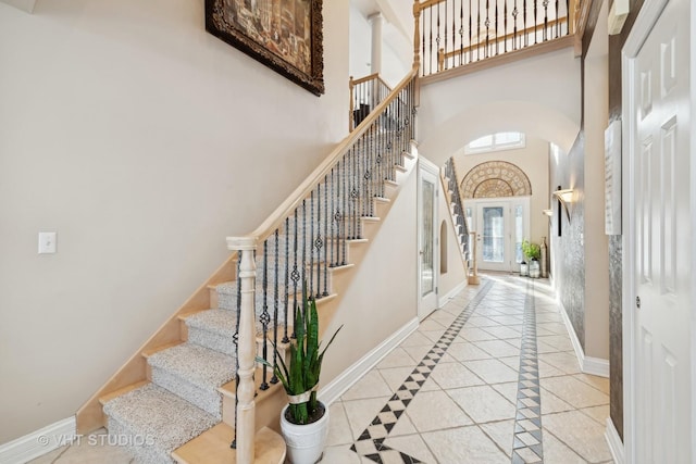 foyer featuring a high ceiling and light tile patterned floors