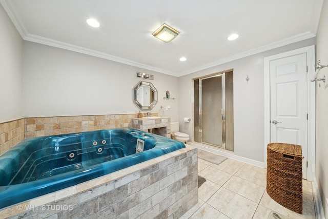 bathroom featuring tile patterned flooring, a relaxing tiled tub, ornamental molding, and toilet