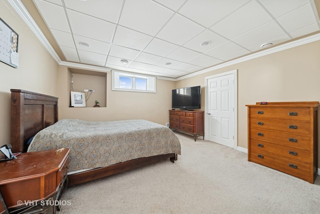 carpeted bedroom with a drop ceiling and ornamental molding