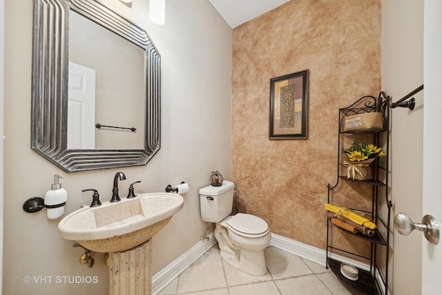 bathroom featuring toilet and tile patterned flooring