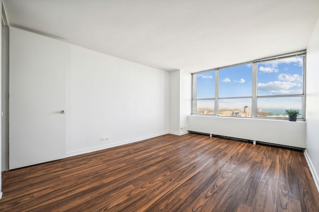 spare room featuring dark hardwood / wood-style flooring