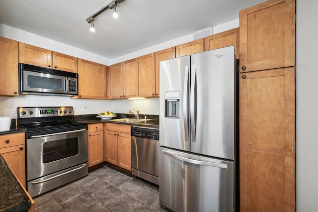 kitchen featuring sink, stainless steel appliances, and track lighting