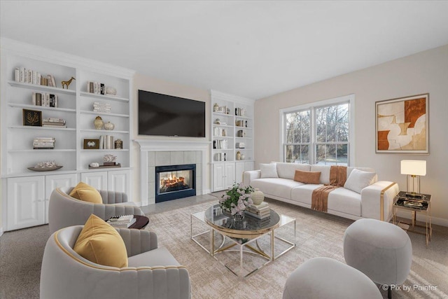 carpeted living room with built in shelves and a fireplace