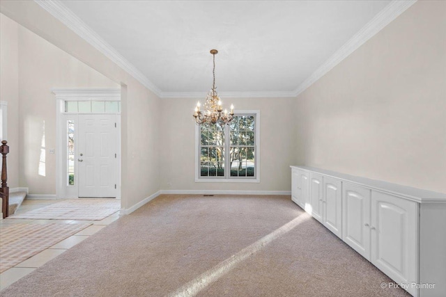 tiled entryway featuring crown molding and an inviting chandelier