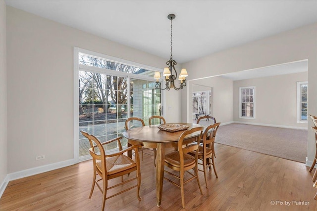 dining room featuring light hardwood / wood-style flooring and a chandelier