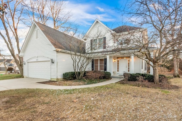 view of property featuring a garage and a front lawn