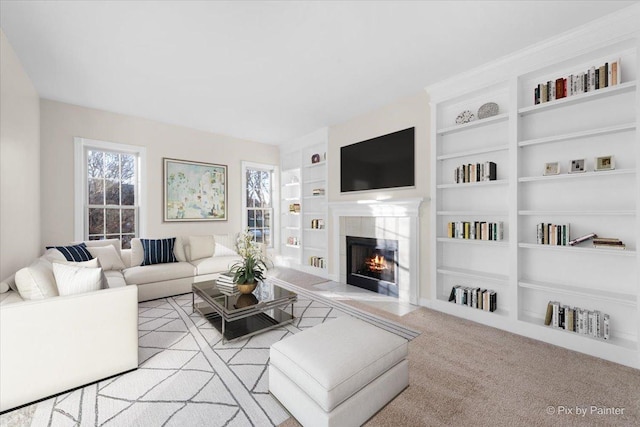 carpeted living room with built in features and a fireplace