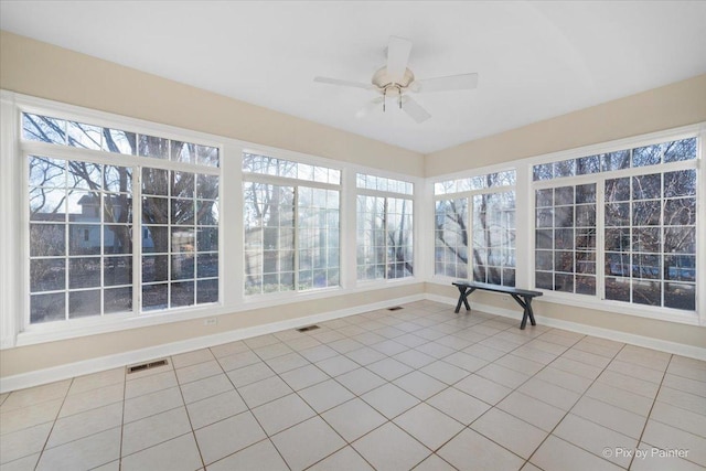 unfurnished sunroom featuring ceiling fan