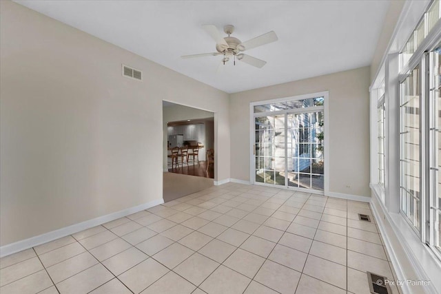 tiled empty room featuring ceiling fan