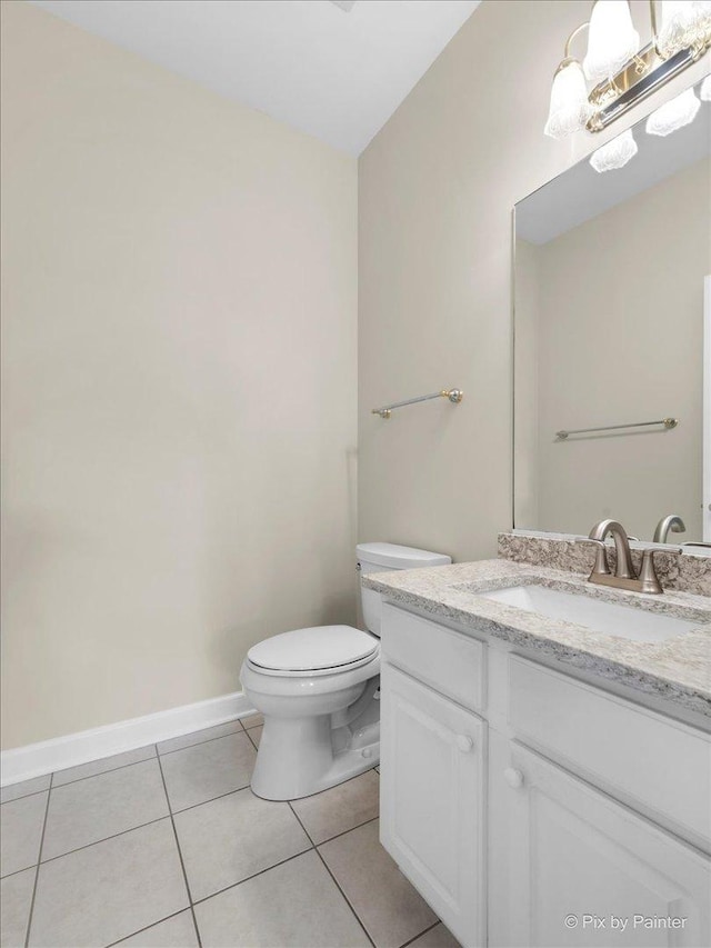 bathroom with tile patterned flooring, vanity, and toilet