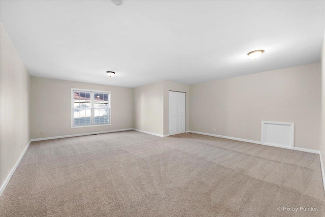 empty room with light colored carpet