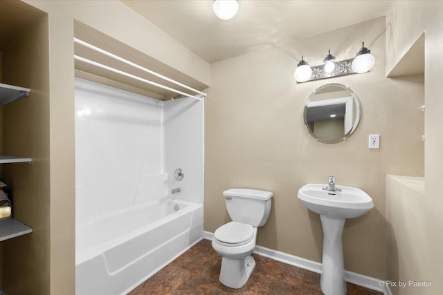 bathroom featuring shower / bathing tub combination and toilet