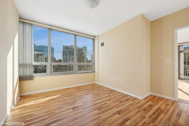 empty room with light hardwood / wood-style flooring