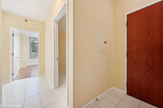 hallway with light tile patterned flooring and electric panel