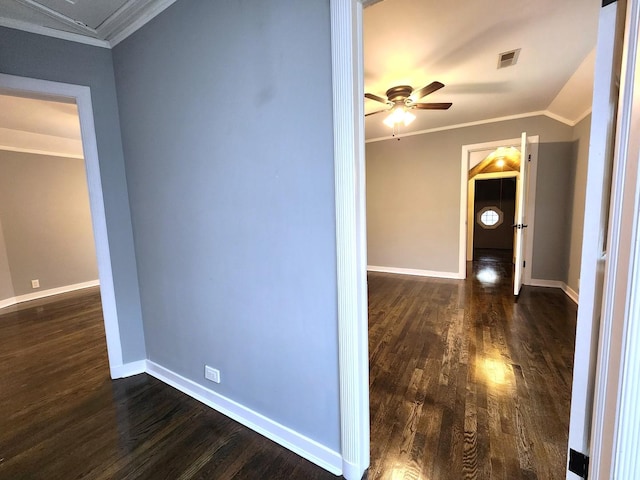 corridor with dark hardwood / wood-style floors, lofted ceiling, and crown molding