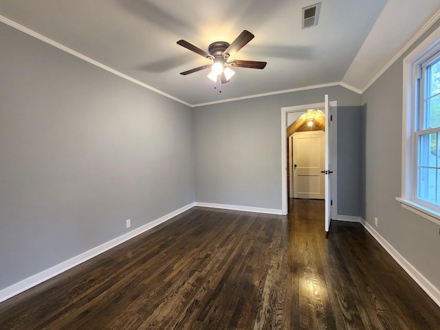 empty room with ceiling fan, crown molding, dark wood-type flooring, and vaulted ceiling