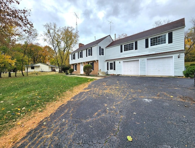 view of front property with a garage and a front lawn