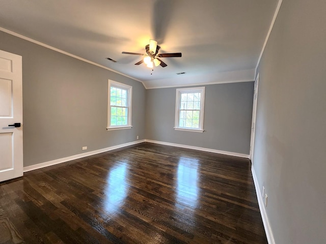 empty room featuring ceiling fan, crown molding, and dark wood-type flooring