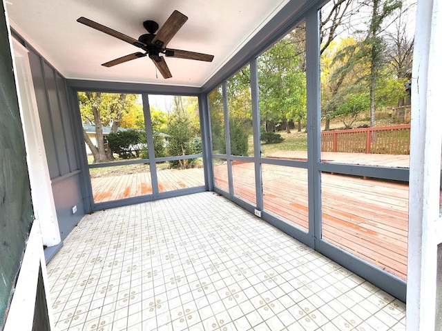 unfurnished sunroom with ceiling fan