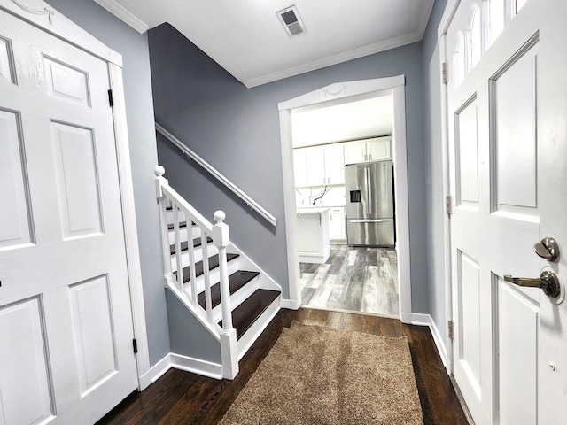 foyer entrance featuring dark hardwood / wood-style floors and ornamental molding