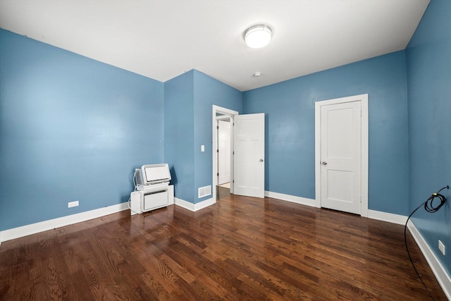 unfurnished room with dark hardwood / wood-style floors