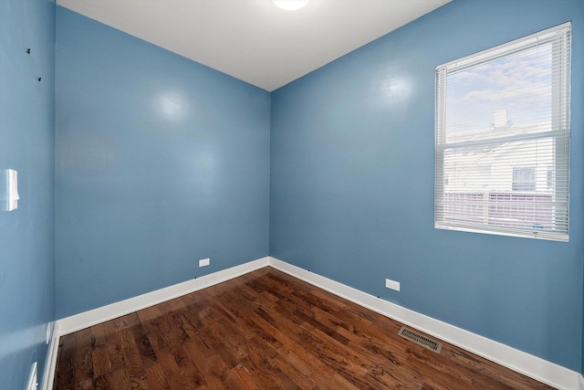 spare room featuring dark wood-type flooring