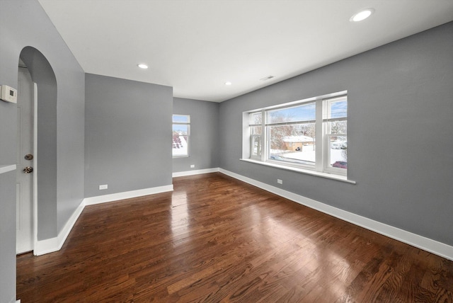 unfurnished room featuring dark wood-type flooring