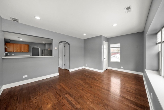 unfurnished living room featuring dark hardwood / wood-style flooring