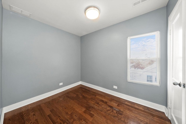 unfurnished room with dark wood-type flooring