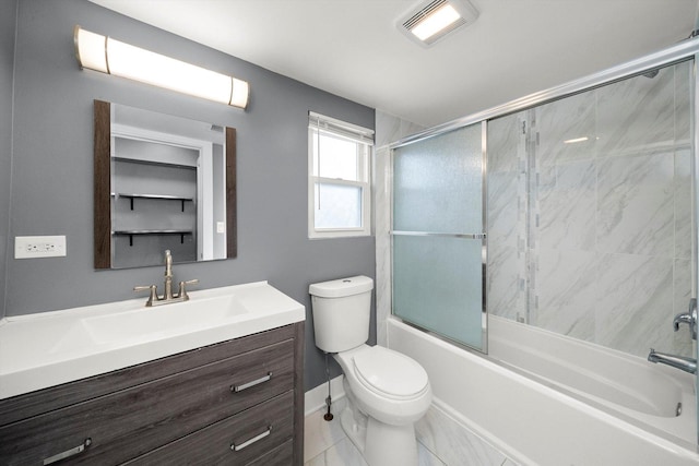 full bathroom featuring vanity, toilet, and bath / shower combo with glass door