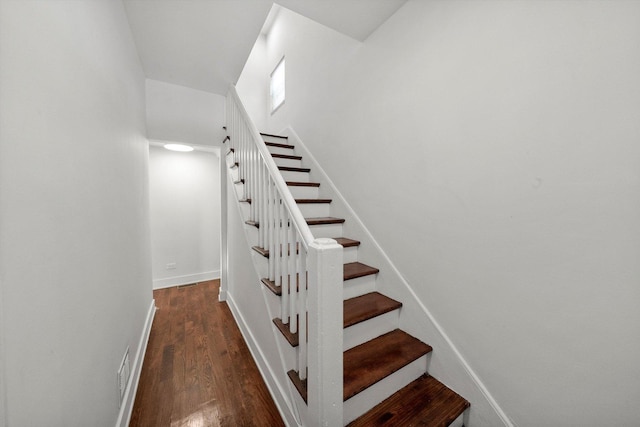 stairway with hardwood / wood-style floors