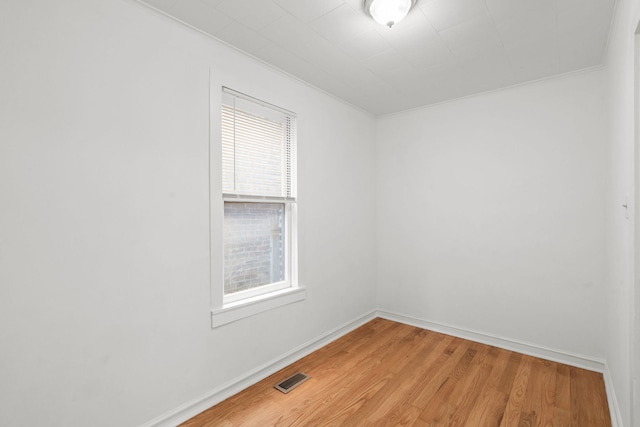 unfurnished room with hardwood / wood-style floors