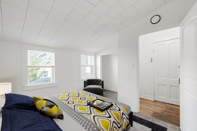 carpeted bedroom featuring lofted ceiling